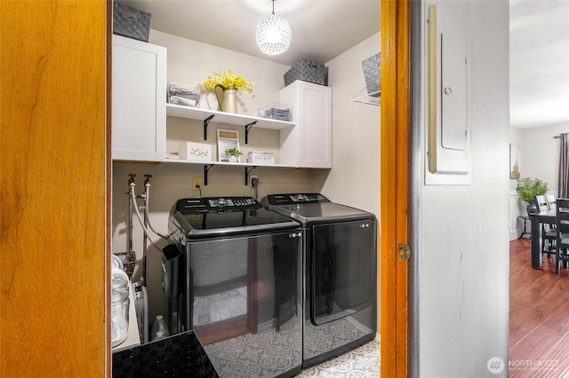 407 Offut Dr, Moses Lake, WA 98837 - laundry room with cabinet space, washer and clothes dryer, and wood finished floors