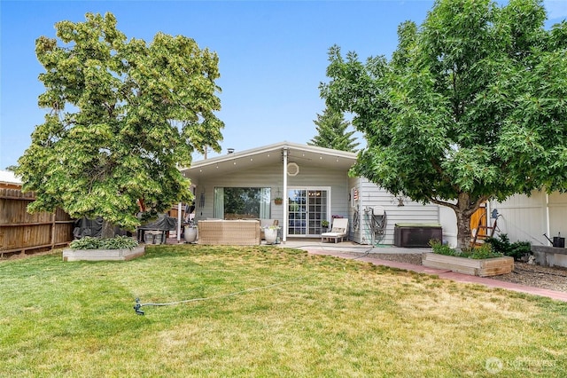 407 Offut Dr, Moses Lake, WA 98837 - back of property with a patio area and a vegetable garden