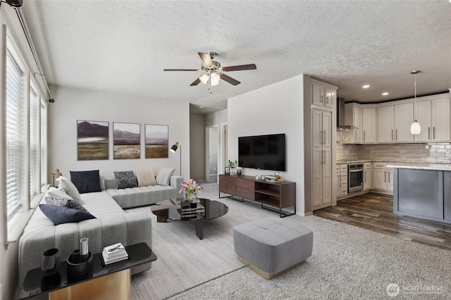1701 E Burr Ave Unit 67, Moses Lake, WA 98837 - carpeted living room featuring ceiling fan, a textured ceiling, recessed lighting, and wood finished floors