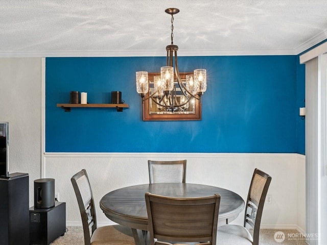2613 172nd Pl SE, Bothell, WA 98012 - carpeted dining room with a chandelier, a textured ceiling, wainscoting, and crown molding