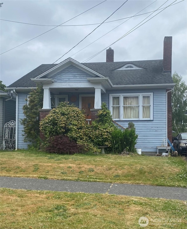 7324 27th Ave NW, Seattle, WA 98117 - view of front facade with a chimney and a front lawn
