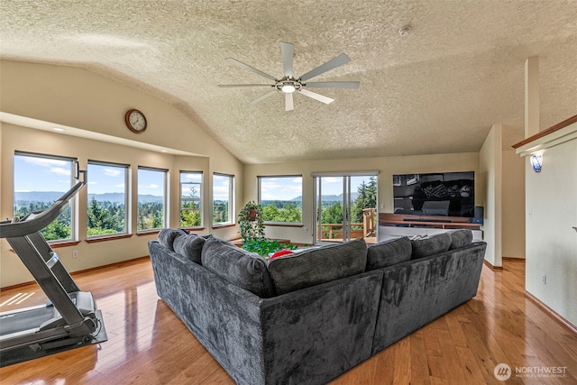 874 W State Route 4, Cathlamet, WA 98612 - living area featuring lofted ceiling, ceiling fan, wood finished floors, and a textured ceiling