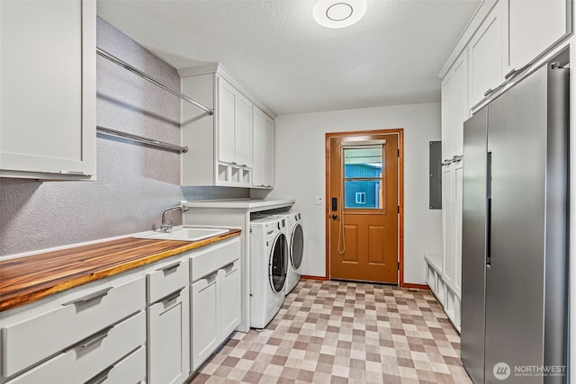 874 W State Route 4, Cathlamet, WA 98612 - washroom featuring cabinet space, washer and dryer, light floors, electric panel, and a textured ceiling