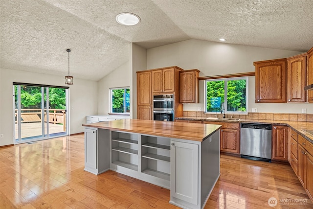 874 W State Route 4, Cathlamet, WA 98612 - kitchen featuring appliances with stainless steel finishes, open shelves, vaulted ceiling, a textured ceiling, and butcher block countertops