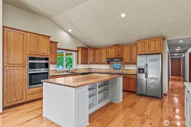 874 W State Route 4, Cathlamet, WA 98612 - kitchen with stainless steel appliances, butcher block counters, under cabinet range hood, a kitchen island, and light wood-style flooring