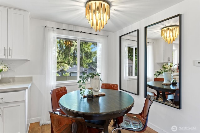 12629 SE 169th St, Renton, WA 98058 - dining space with a chandelier and light wood-type flooring