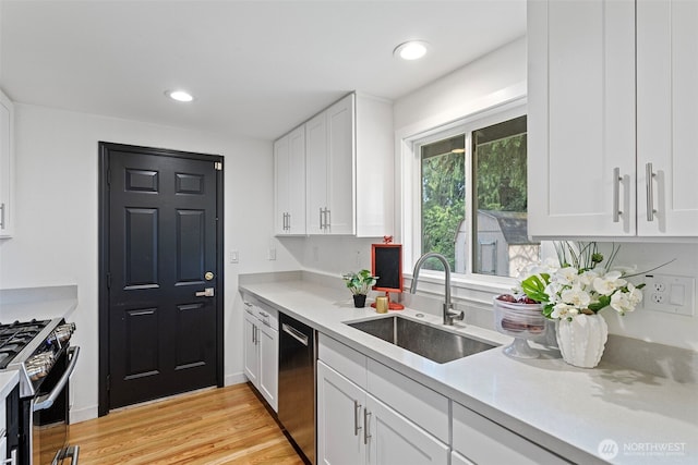 12629 SE 169th St, Renton, WA 98058 - kitchen featuring appliances with stainless steel finishes, white cabinetry, light countertops, light wood-style flooring, and recessed lighting