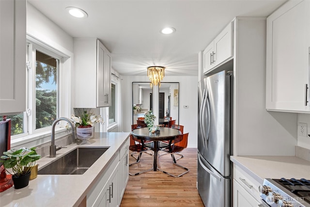 12629 SE 169th St, Renton, WA 98058 - kitchen featuring freestanding refrigerator, healthy amount of natural light, light wood-style flooring, light countertops, and recessed lighting