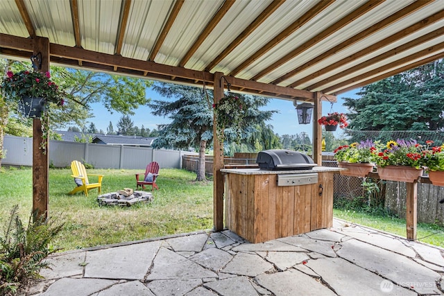 12629 SE 169th St, Renton, WA 98058 - fenced backyard with a patio, a fire pit, and exterior kitchen