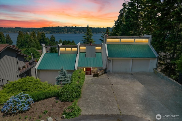 2838 170th Ave SE, Bellevue, WA 98008 - view of front of home with driveway, a metal roof, and a garage