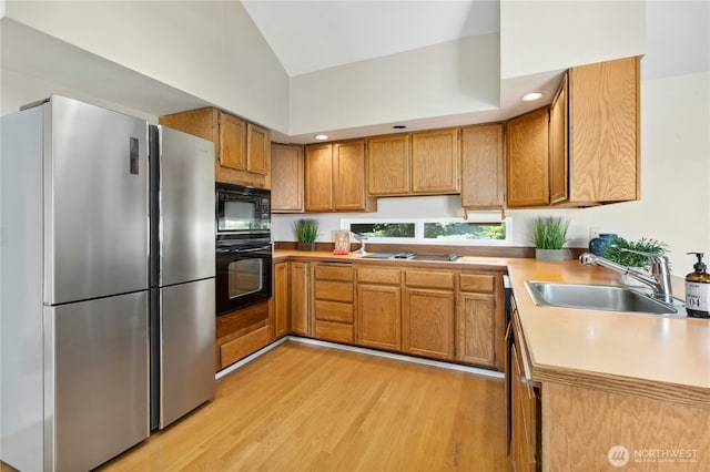2838 170th Ave SE, Bellevue, WA 98008 - kitchen with black appliances, light wood-style floors, brown cabinetry, and lofted ceiling