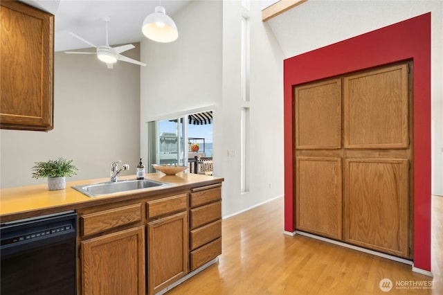 2838 170th Ave SE, Bellevue, WA 98008 - kitchen featuring black dishwasher, high vaulted ceiling, a ceiling fan, light wood finished floors, and brown cabinetry