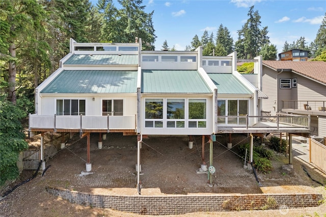 2838 170th Ave SE, Bellevue, WA 98008 - rear view of property with a wooden deck, a metal roof, and a sunroom