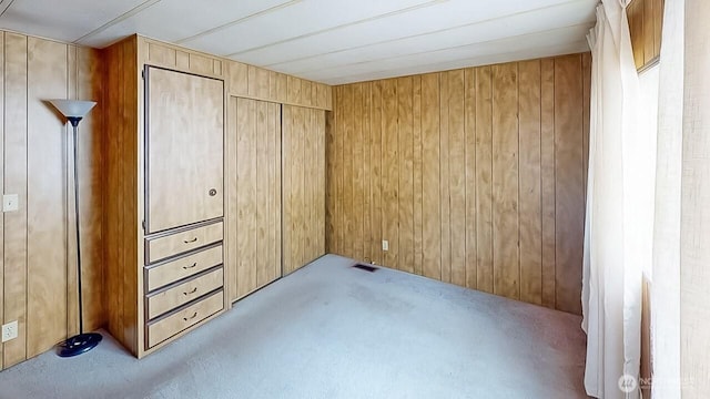 11453 Bayview Edison Rd Unit 25, Mount Vernon, WA 98273 - unfurnished bedroom with carpet, wood walls, and a closet