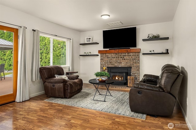 9512 Woods Pl, Snohomish, WA 98296 - living room with healthy amount of natural light, a fireplace, and wood finished floors