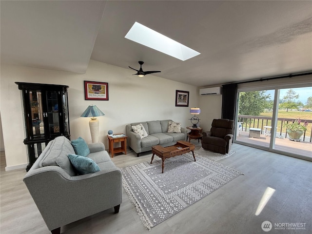 440 W Nelson Rd, Sequim, WA 98382 - living area with an AC wall unit, a skylight, light wood-style flooring, and ceiling fan
