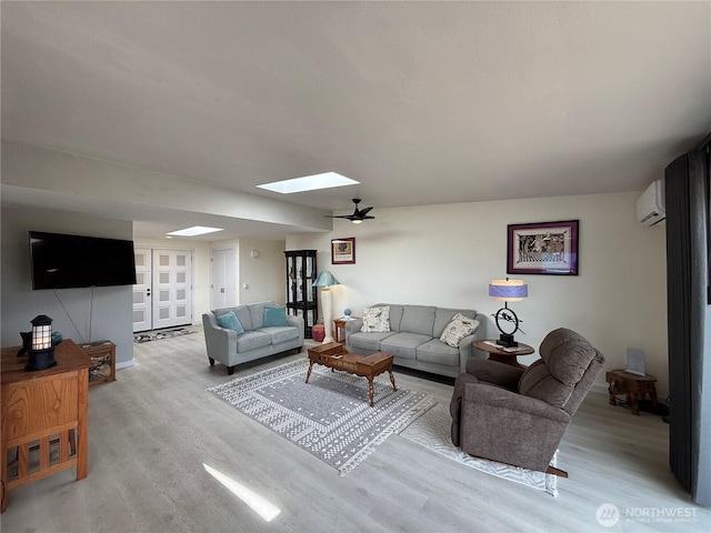 440 W Nelson Rd, Sequim, WA 98382 - living area featuring a wall unit AC, a skylight, and light wood-style floors
