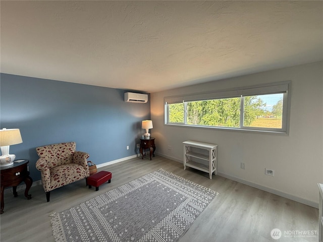 440 W Nelson Rd, Sequim, WA 98382 - sitting room featuring a wall mounted AC and wood finished floors