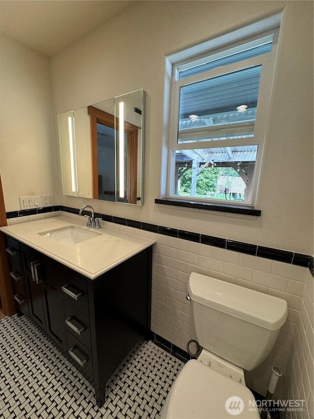 8329 20th St SE, Lake Stevens, WA 98258 - bathroom with vanity, tile walls, a wainscoted wall, and tile patterned floors
