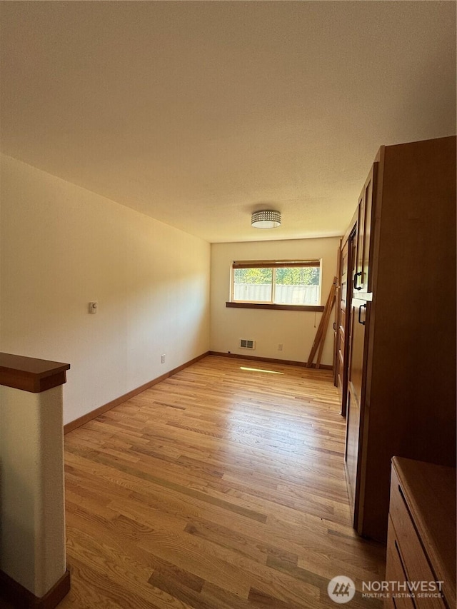 8329 20th St SE, Lake Stevens, WA 98258 - spare room with light wood-type flooring and baseboards
