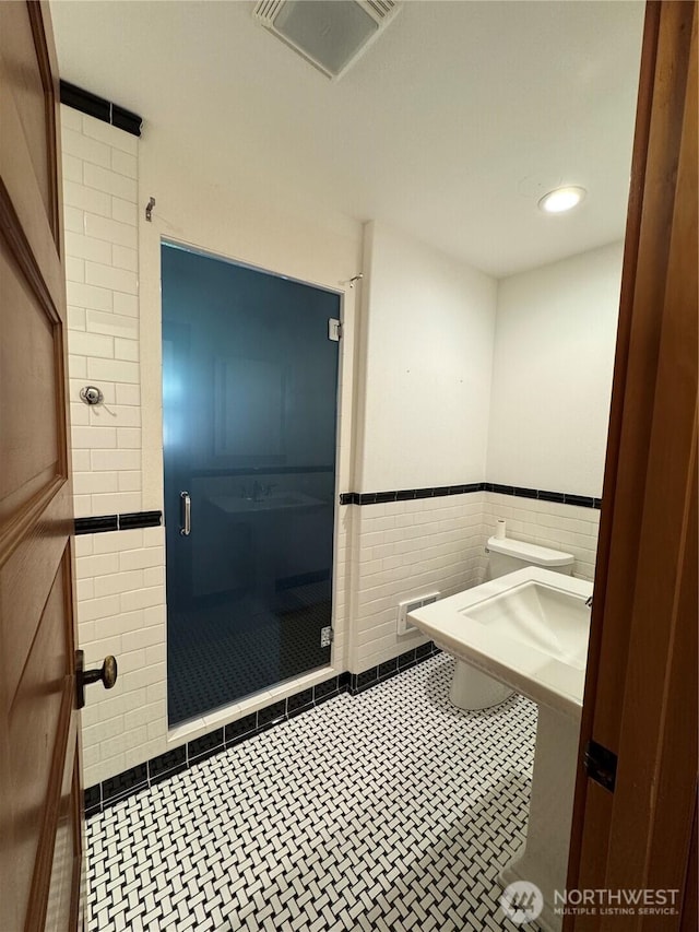 8329 20th St SE, Lake Stevens, WA 98258 - bathroom with tile walls, wainscoting, recessed lighting, and a shower stall