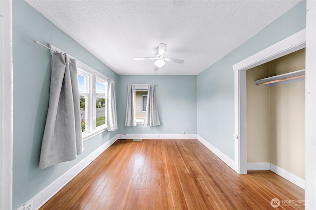 2304 F St, Bellingham, WA 98225 - unfurnished bedroom with hardwood / wood-style floors, a textured ceiling, and a ceiling fan