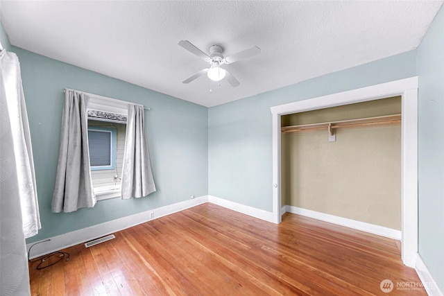 2304 F St, Bellingham, WA 98225 - unfurnished bedroom with wood finished floors, ceiling fan, and a closet