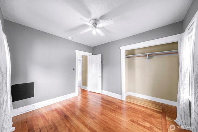 2304 F St, Bellingham, WA 98225 - unfurnished bedroom with hardwood / wood-style floors, a closet, and a ceiling fan