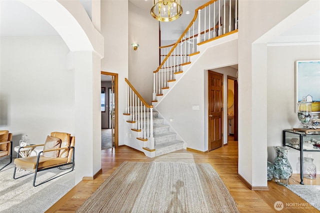 9673 NE Pilot Ct, Kingston, WA 98346 - entryway with wood finished floors, arched walkways, stairs, and a high ceiling