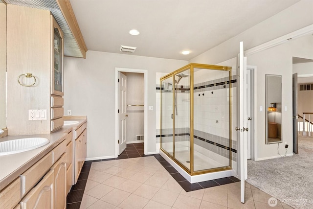 9673 NE Pilot Ct, Kingston, WA 98346 - bathroom featuring tile patterned floors, a shower stall, double vanity, and recessed lighting