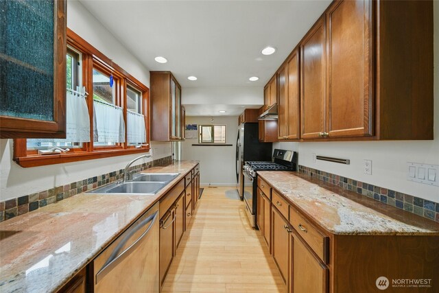634 University St, Walla Walla, WA 99362 - kitchen featuring appliances with stainless steel finishes, light wood-style floors, recessed lighting, under cabinet range hood, and light stone counters