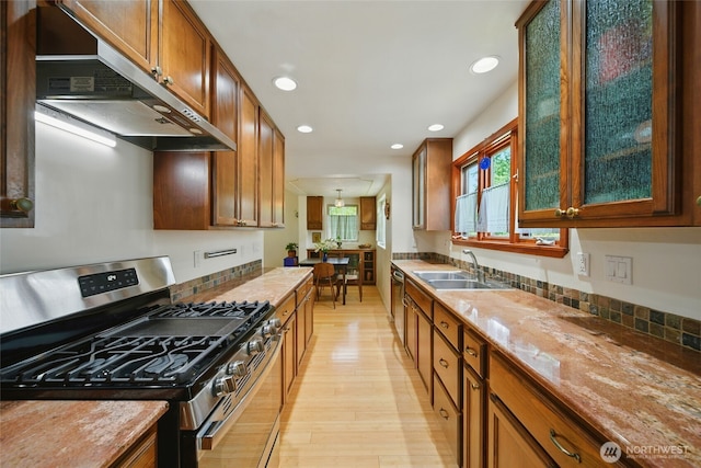 634 University St, Walla Walla, WA 99362 - kitchen featuring stainless steel appliances, exhaust hood, light wood finished floors, recessed lighting, and brown cabinetry
