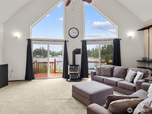 2519 Carpenter Rd, Lacey, WA 98503 - living area featuring high vaulted ceiling, a wood stove, a water view, carpet, and ceiling fan