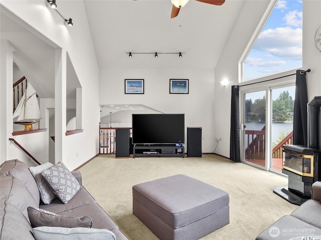 2519 Carpenter Rd, Lacey, WA 98503 - living area with carpet flooring, a ceiling fan, a wood stove, track lighting, and high vaulted ceiling