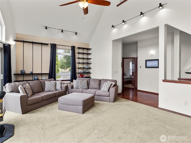 2519 Carpenter Rd, Lacey, WA 98503 - living room with carpet flooring, a ceiling fan, high vaulted ceiling, rail lighting, and wood finished floors