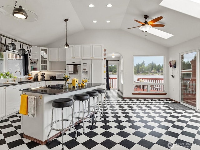 2519 Carpenter Rd, Lacey, WA 98503 - kitchen featuring light floors, dark countertops, healthy amount of natural light, lofted ceiling, and recessed lighting