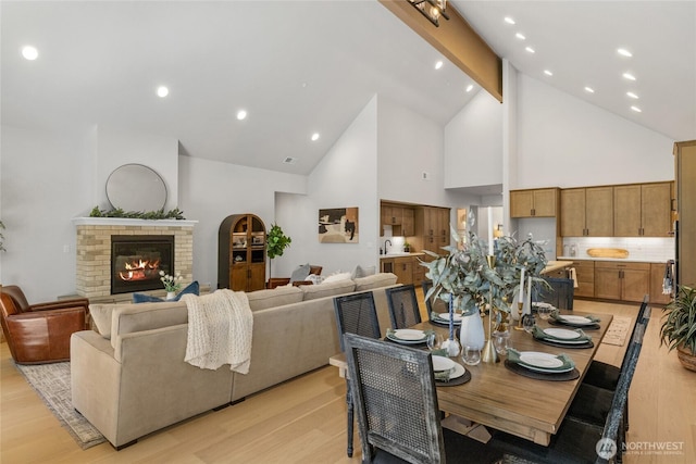 81 Plateau Loop, Cle Elum, WA 98922 - dining space with high vaulted ceiling, beamed ceiling, light wood finished floors, a brick fireplace, and recessed lighting