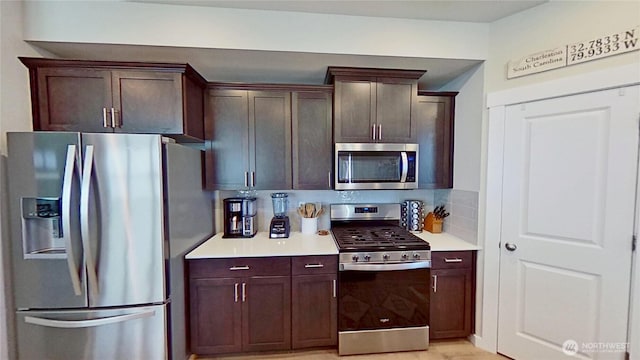 5845 Waverly Rd SW, Port Orchard, WA 98367 - kitchen featuring appliances with stainless steel finishes, decorative backsplash, light countertops, and dark brown cabinetry