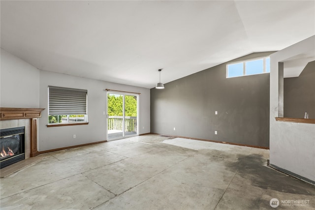 16411 156th St SE, Monroe, WA 98272 - unfurnished living room with lofted ceiling, a tiled fireplace, and concrete flooring