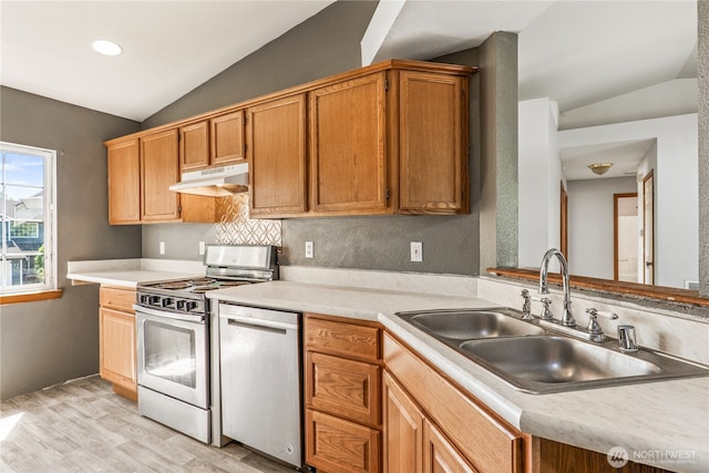 16411 156th St SE, Monroe, WA 98272 - kitchen featuring stainless steel appliances, lofted ceiling, under cabinet range hood, light countertops, and light wood finished floors