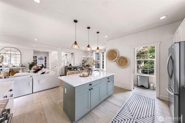 2166 NE Morgan Ln, Issaquah, WA 98029 - kitchen with freestanding refrigerator, a kitchen island, light wood finished floors, and recessed lighting