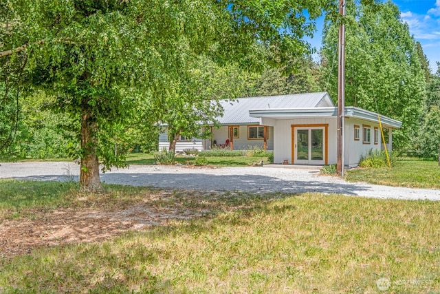 14985 Chumstick, Leavenworth, WA 98826 - view of front of home featuring french doors, a metal roof, and a front yard
