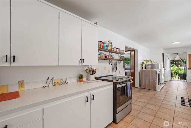 14985 Chumstick, Leavenworth, WA 98826 - kitchen featuring stainless steel range with electric cooktop, light countertops, light tile patterned floors, white cabinets, and open shelves