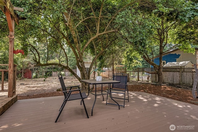 7040 SE Truman St, Port Orchard, WA 98366 - wooden deck with a fenced backyard and outdoor dining area