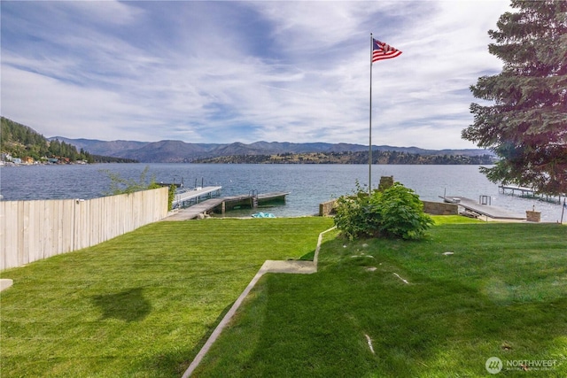 9368 S Lakeshore Rd, Chelan, WA 98816 - view of grassy yard featuring a boat dock and a water and mountain view
