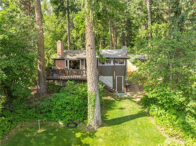 9368 S Lakeshore Rd, Chelan, WA 98816 - view of front facade featuring a chimney, stairway, a deck, a front lawn, and a wooded view