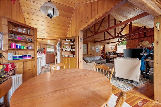 9368 S Lakeshore Rd, Chelan, WA 98816 - dining area with radiator, wood walls, vaulted ceiling, wood finished floors, and wooden ceiling