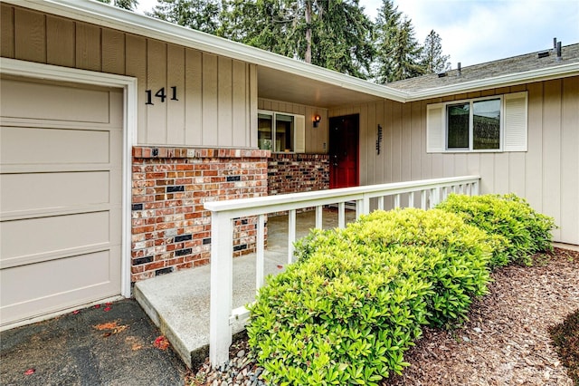 141 Leslie Ln, Sequim, WA 98382 - entrance to property with brick siding, an attached garage, and a shingled roof