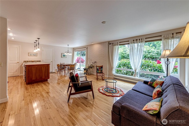 141 Leslie Ln, Sequim, WA 98382 - living area featuring light wood-type flooring, baseboard heating, and a chandelier