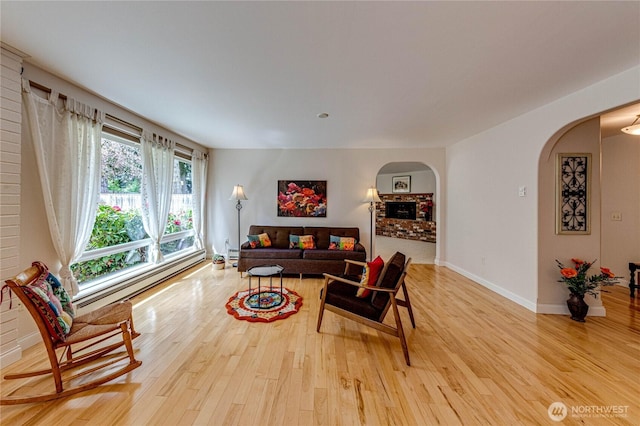141 Leslie Ln, Sequim, WA 98382 - living room with arched walkways, light wood-style floors, and baseboard heating